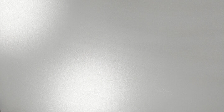 Close up, textured blurred frosted glass. Color is a light, cool gray with bright white highlights where the light source hits, creating a sense of depth and soft, ethereal glow.