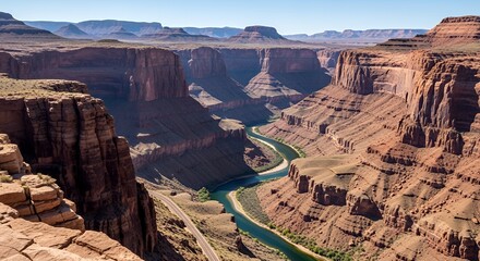 Grand Canyon Landscape with River and Rocky Cliffs Under Clear Blue Sky