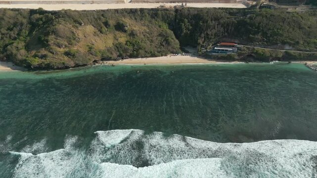Drone Pan Up Over Rugged Uluwatu Cliffs And Hidden Beach Bali Indonesia 4K 60FPS