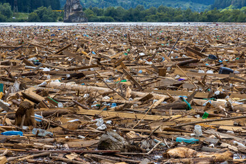 Lots of waste floating on the surface of the water. Various garbage on the surface of Lake Izvorul Muntelui - Romania brought by the flood