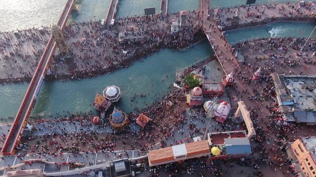 4k Aerial Drone shot of huge crowd at river ganges  har ki pauri  during a hindu festival Kumbh Mela in Haridwar , Uttarakhand,India 
