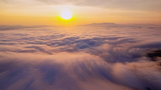 Amazing sunrise with fog move flowing over mountains,Sunrise sky,Aerial view Drone flies over clouds,Rainforest Clouds and fog in sunrise light, Nature and travel background