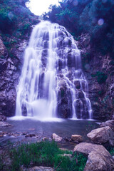 Waterfall falling from the rocks and trees around it in middle of forest and mountain in Jijel, Algeria, Africa, Beautiful waterfall for landscape, River waterfall, rain water and stream, water fall.