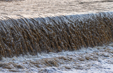 A waterfall with dirty water