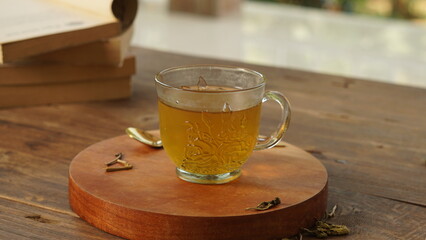 cup of tea, tea being poured into a transparent and white tea cup, teapot and tea cup with floral motif, darmkmood tea photo display