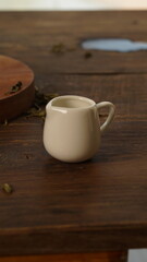 cup of tea, tea being poured into a transparent and white tea cup, teapot and tea cup with floral motif, darmkmood tea photo display