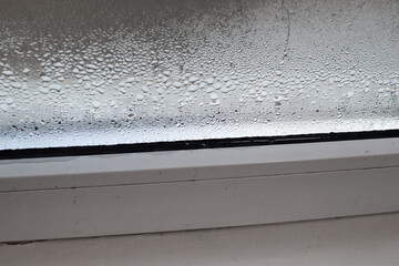 dampness on the wet glass of a plastic window.