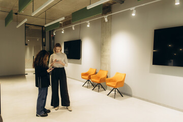 Businesswomen Engaged in Discussion in a Modern Office Environment