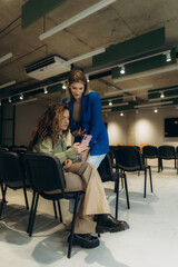 Fototapeta premium Two Women Collaborating in a Modern Office Conference Space