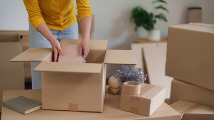 Adult preparing move packing cardboard boxes new home apartment residential relocation organizing...