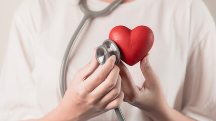 woman uses a stethoscope to check the heartbeat. hospital life insurance concept, world heart health day. doctor day