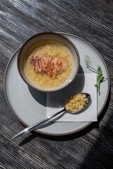 Chicken broth with noodles on a wooden table. 