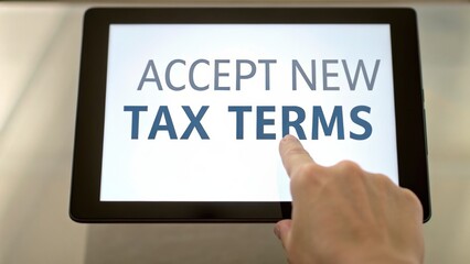 Naklejka premium tax increase Hand pressing a tablet screen displaying 