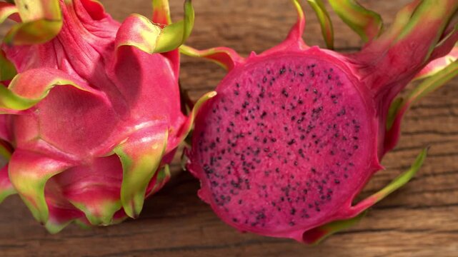 Red-fleshed pitaya or Dragon Fruit. Tropical fruits healthy dragon fruits. Sliced dragon fruit on plate, wooden background, healthy food.