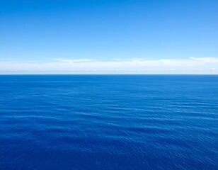 Fototapeta premium Vast expanse of cerulean sea meets a pristine azure sky under gentle horizon