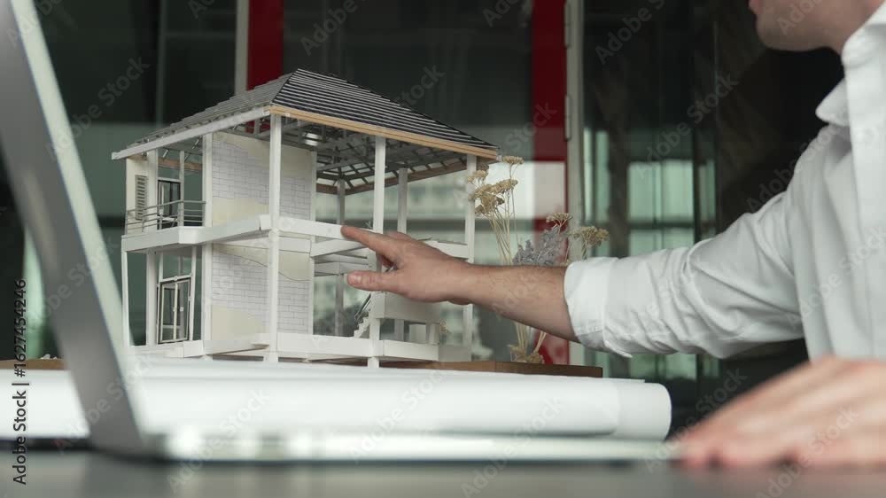 Aufkleber closeup of skilled caucasian architect engineer hand compare house design between model and blueprin