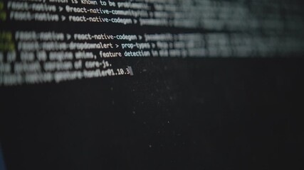 A close-up shot of a computer's command line interface. A blinking cursor and running text show a system process or script executing. Concept of hacking or software development - Powered by Adobe
