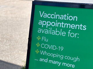 Vaccination appointments sign outside pharmaceutical store