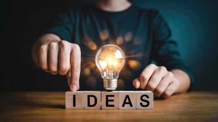 Ignite your next big idea with a glowing lightbulb and 'IDEAS' spelled out in wooden blocks