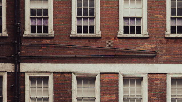 Vintage red brick building showcasing historic English architectural details