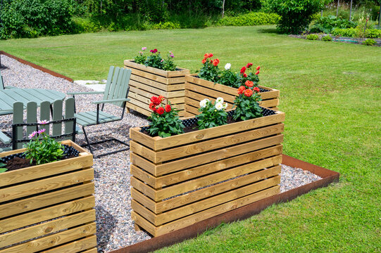 Old outdoor furniture and newely built high flower beds