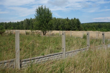 Concrete fence in progress building in village.