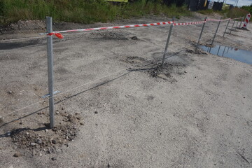 Building protecting fence, near road in progress.
