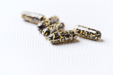 Iron capsules on bright background. Soft focus. Close up. Copy space.