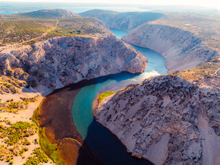 View of the Zrmanja River Canyon in Croatia, with winding turquoise waters cutting through...