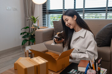 she is packing parcel to send to all customers, this entrepreneur own a small business, sme,...