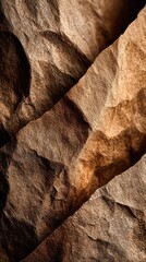 Abstract close-up of crumpled brown paper, showing texture and shadows