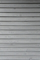 Obraz premium A closeup of a gray wood plank wall creates a rustic and textured backdrop