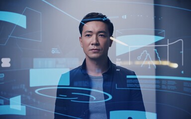 A man with a serious expression stands in a dimly lit setting, surrounded by futuristic blue digital interface elements and data projections.