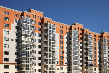 Lviv, Ukraine - 3 4 2020: Facade of a tall multi-storey modern house with balconies and large glass windows. Design of modern architecture. Top view from the bottom. Modern city architecture