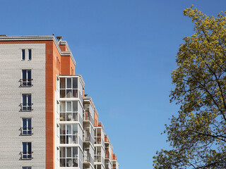 Lviv, Ukraine - 3 4 2020: Facade of a tall multi-storey modern house with balconies and large glass...