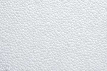 Closeup of white foam beads tightly fused in random pattern, creating durable packaging material texture ideal for industrial design