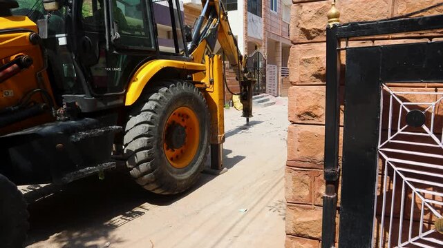 construction digger operating on road under daylight