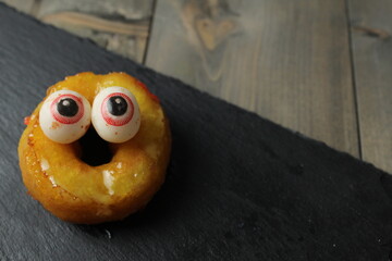 Halloween Cake. Pochik with yellow glaze and eyes. Halloween Treats