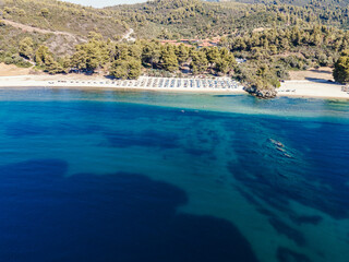 Blue calm sea waters with coast and beach.
