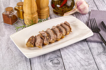 Roasted duck breast slices in the plate
