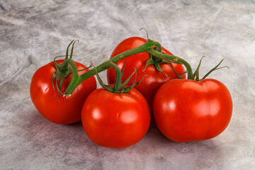 Ripe fresh tomato on the branch