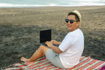 Asian young handsome businessman use laptop computer working in yacht. Attractive male freelance...