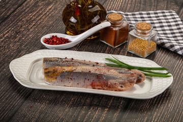 Salted marinated herring fillet with spices