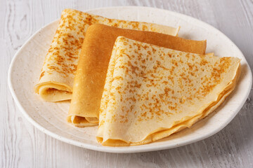 Freshly cooked pancakes on a wooden white table