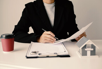 Businesswoman real estate agent signs documents and gives home insurance advice Create a home...