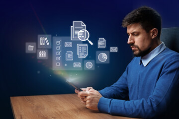 Professional man engaged in digital task on smartphone while working at desk with connected icons in background