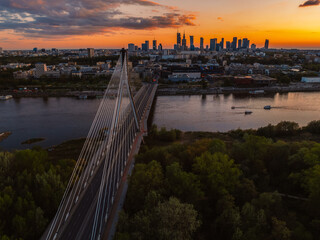 Warsaw city center and skyscrapers in the background Vistula river and Swietokrzyski bridge. Sunset...