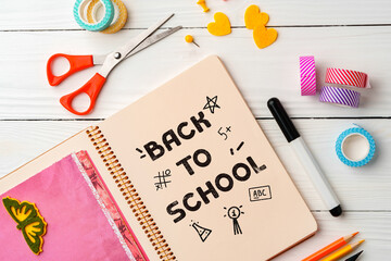 Craft supplies and notebook ready for back to school preparations on a bright workspace with...