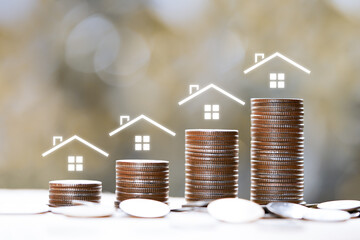 rising stacked coins with house icon