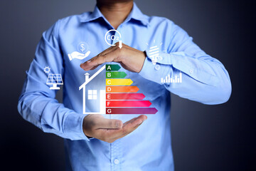 House energy efficiency rating labeling concept with businessman holding label for reduce energy consumption and environmental friendly building